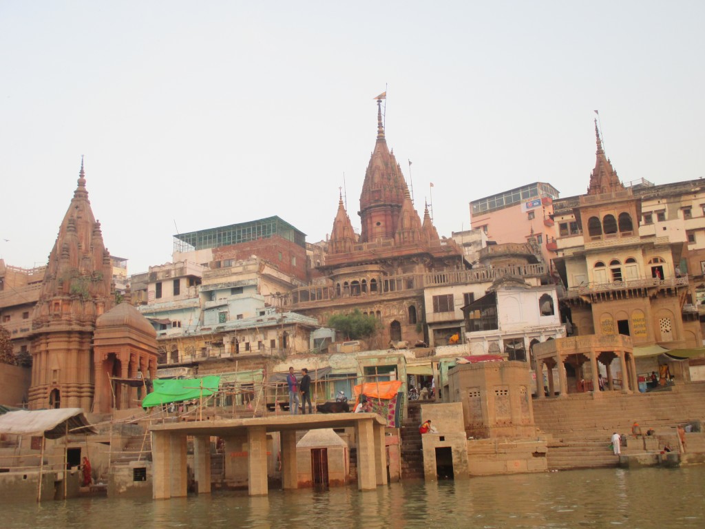 Palace towers, temples, stairs, and the brown water of the holy Ganges